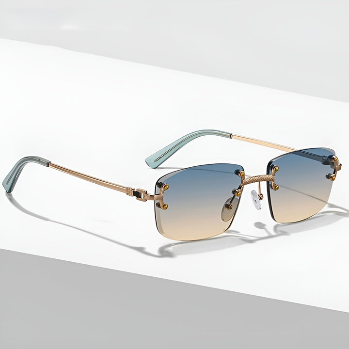 Gafas de sol unisex sin montura, lentes degradados y protección UV400. Estilo moderno, varillas doradas.