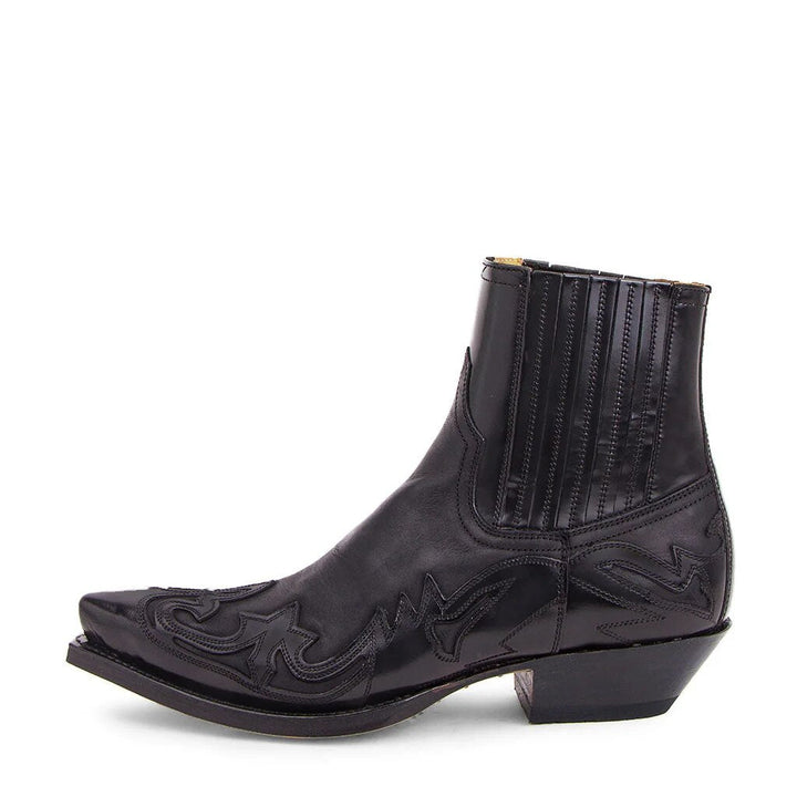 Botas cowboy de hombre en piel sintética negra, con punta afilada y estilo western audaz. Calzado masculino elegante y cómodo.