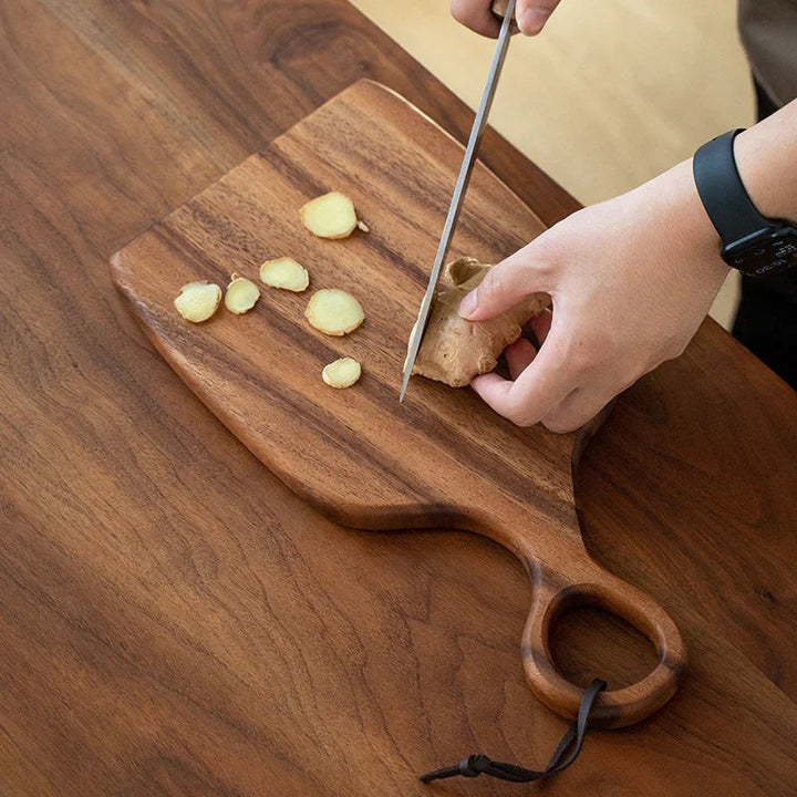 Utensilio de cocina: tabla de madera asimétrica con asa para la preparación de alimentos, diseño orgánico.