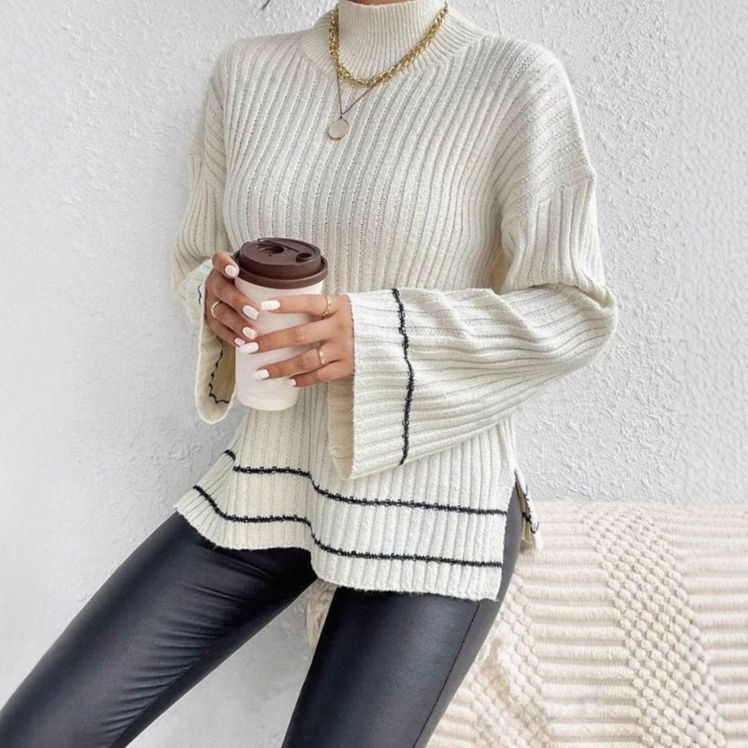 Jersey elegante de mujer con cuello alto y mangas acampanadas para look casual chic. Punto de invierno.