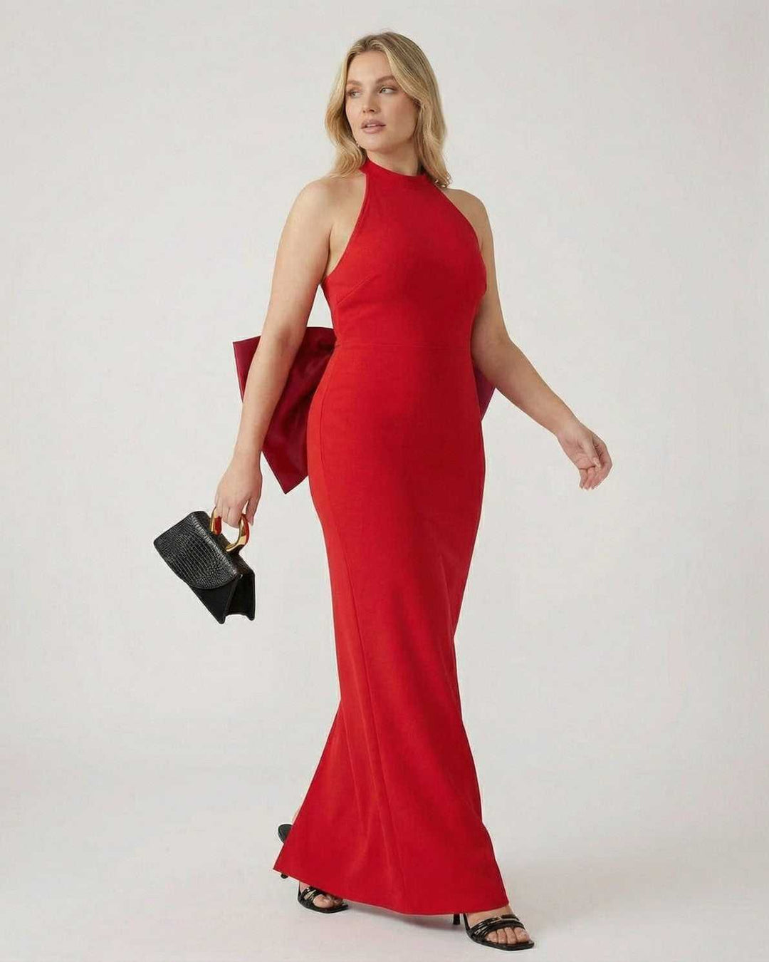 Sofisticado vestido de noche para mujer, diseño maxi con cuello halter y elegante lazo en la espalda.