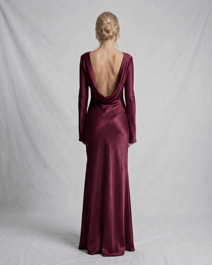 Vestido de noche blanco con espalda baja, silueta ajustada que resalta la figura femenina.