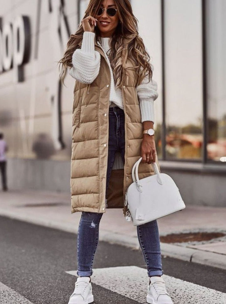 Chaleco mujer acolchado con capucha, largo y sin mangas. Proporciona calidez ligera para la moda de invierno.