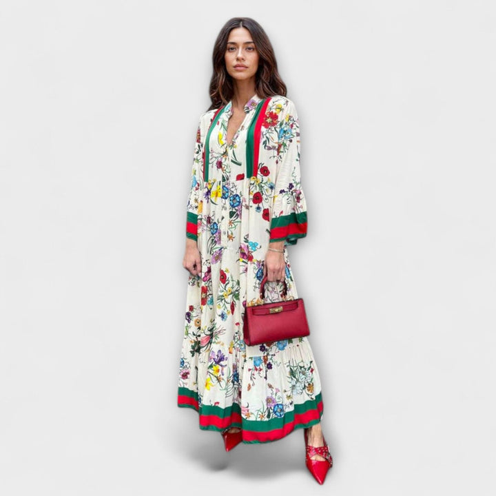 Vestido fluido maxi para mujer, estampado abstracto vibrante. Mangas murciélago y escote en V para un estilo cómodo y chic.