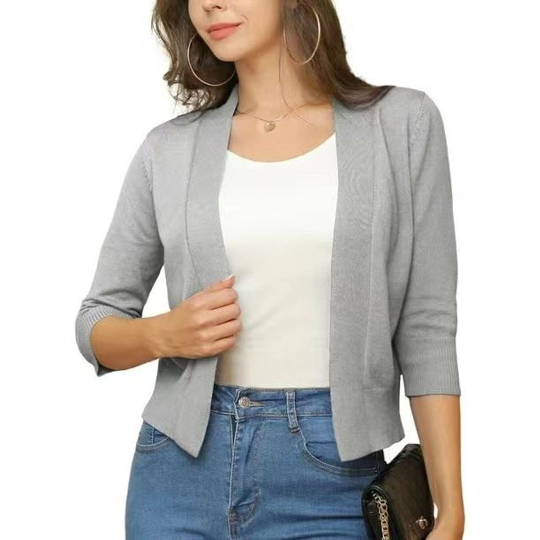 Cárdigan de mujer, corto, manga 3/4, color coral. Capa elegante y abierta para un look vibrante de primavera.