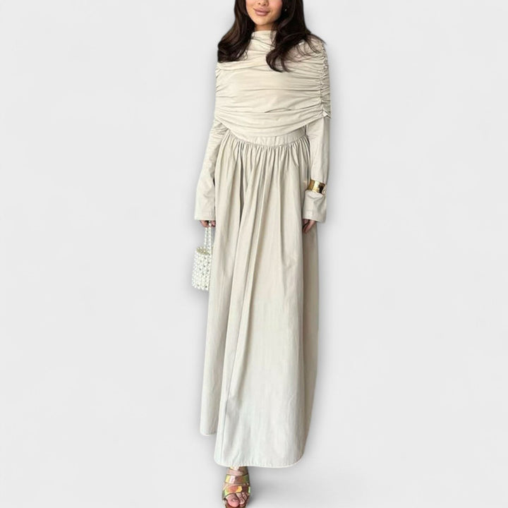 Elegante vestido maxi azul marino plisado de mujer, cuello alto y manga larga, ideal para eventos.